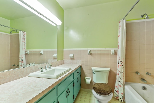 full bathroom with shower / tub combo with curtain, vanity, toilet, and tile walls