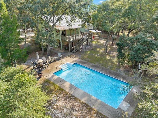 view of pool featuring a deck and a patio area