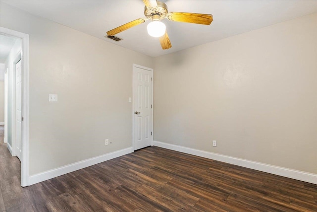 spare room featuring ceiling fan and dark hardwood / wood-style flooring