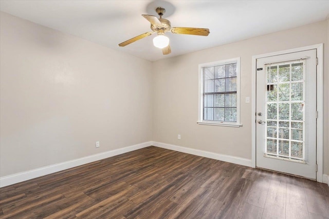 empty room with dark hardwood / wood-style floors and ceiling fan