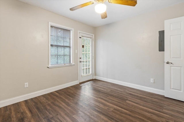 empty room featuring ceiling fan, dark hardwood / wood-style floors, and electric panel