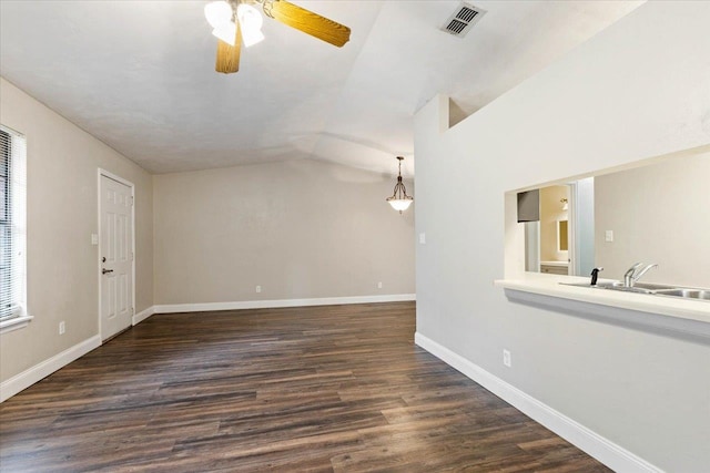 unfurnished living room with ceiling fan, dark hardwood / wood-style floors, sink, and lofted ceiling