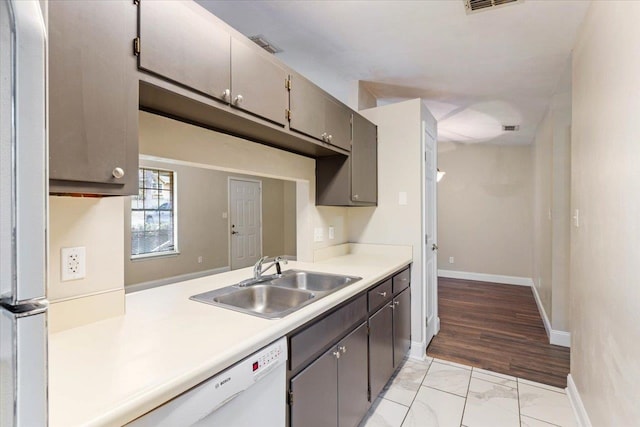 kitchen with light wood-type flooring, sink, and white appliances