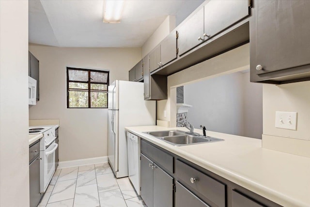 kitchen with white appliances, sink, and vaulted ceiling