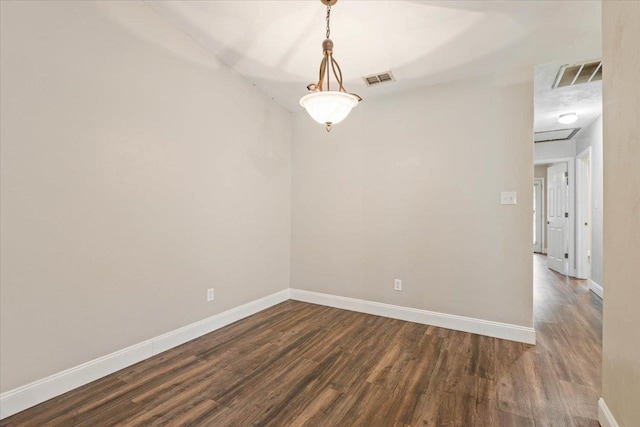 spare room featuring dark wood-type flooring