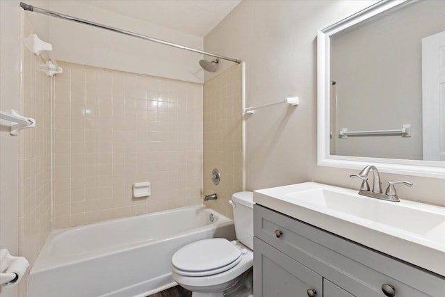 full bathroom featuring toilet, vanity, and tiled shower / bath