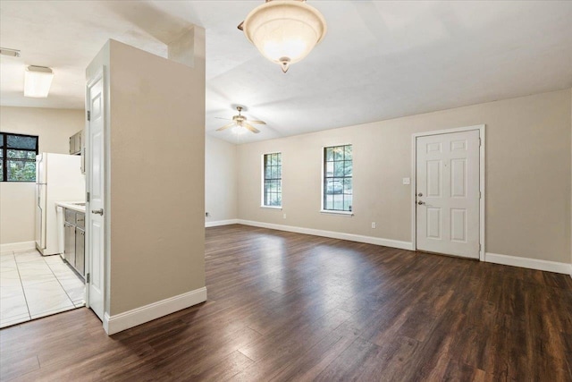 unfurnished living room featuring ceiling fan, wood-type flooring, and vaulted ceiling