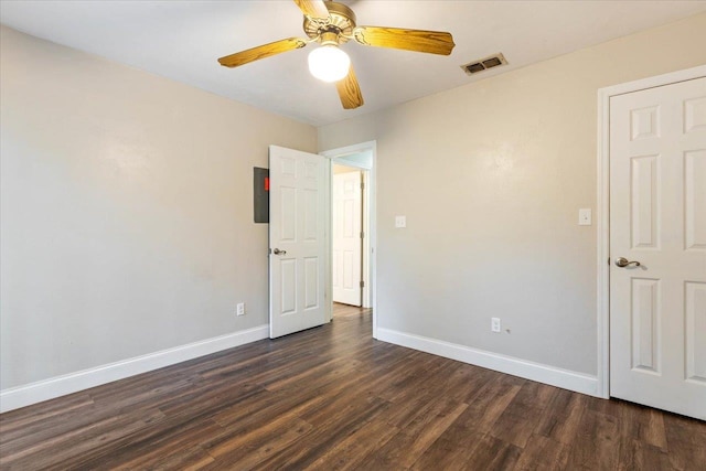 unfurnished bedroom featuring dark wood-type flooring and ceiling fan