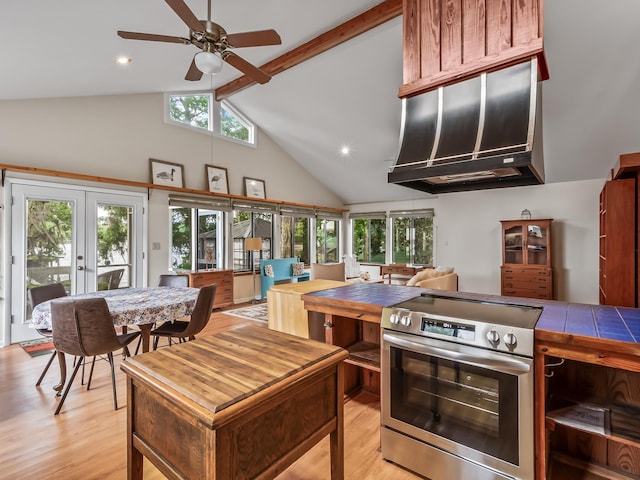 kitchen featuring stainless steel electric stove, a wealth of natural light, french doors, and light wood-style floors