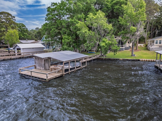 dock area featuring a water view, a yard, and boat lift