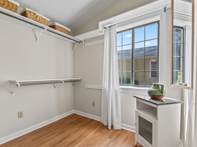 walk in closet featuring wood finished floors