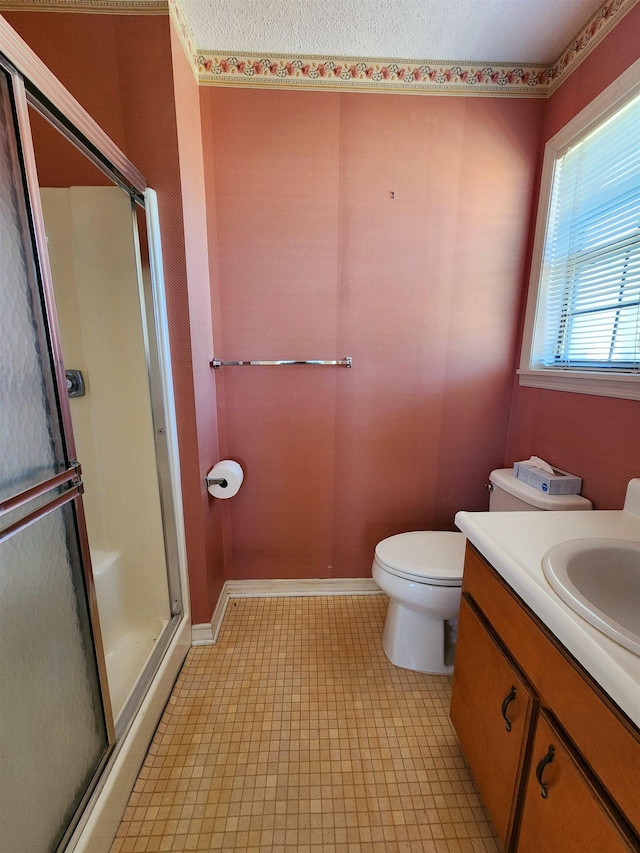 full bathroom with baseboards, toilet, a shower stall, and vanity