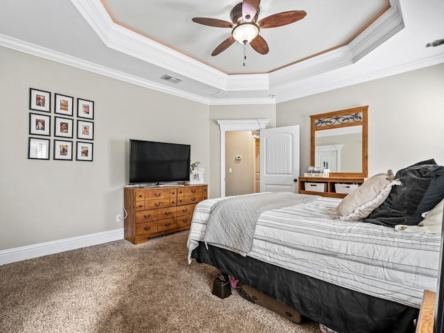 carpeted bedroom featuring a tray ceiling and ornamental molding