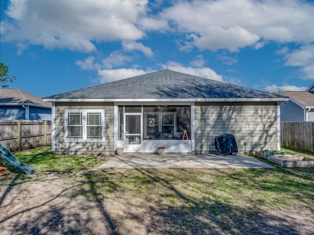 back of property featuring a sunroom, a lawn, and a patio area