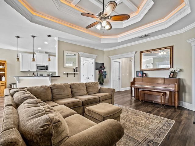 living room with a tray ceiling, ceiling fan, dark hardwood / wood-style flooring, and crown molding