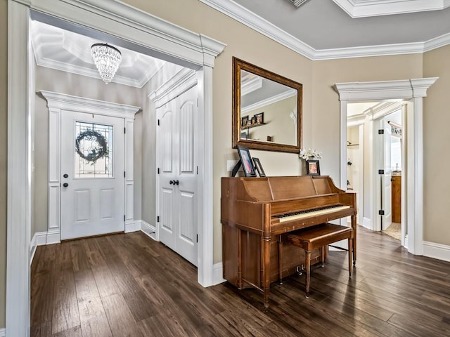 foyer entrance featuring ornamental molding, a chandelier, and dark hardwood / wood-style floors