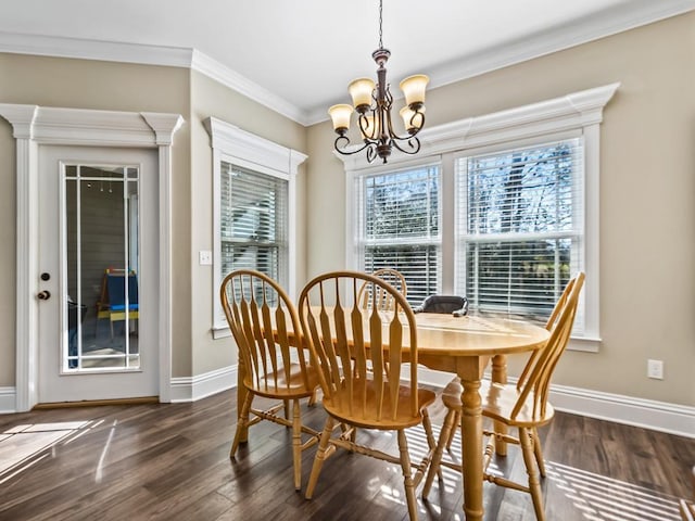 dining area featuring a notable chandelier, dark hardwood / wood-style floors, and ornamental molding