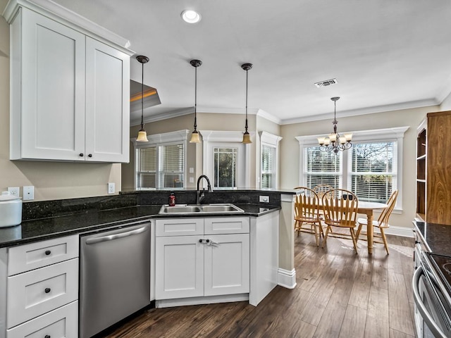 kitchen with white cabinets, hanging light fixtures, stainless steel appliances, and sink