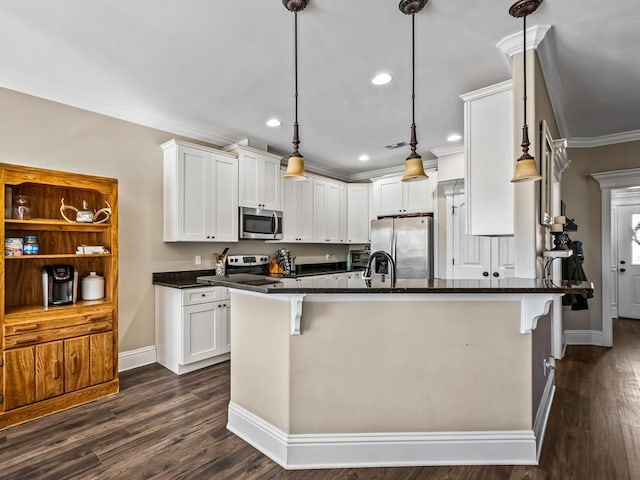 kitchen with white cabinets, stainless steel appliances, and a breakfast bar