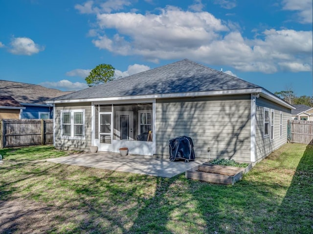 back of house with a yard, a sunroom, and a patio area