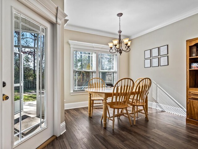 dining area with ornamental molding, a chandelier, and dark hardwood / wood-style floors