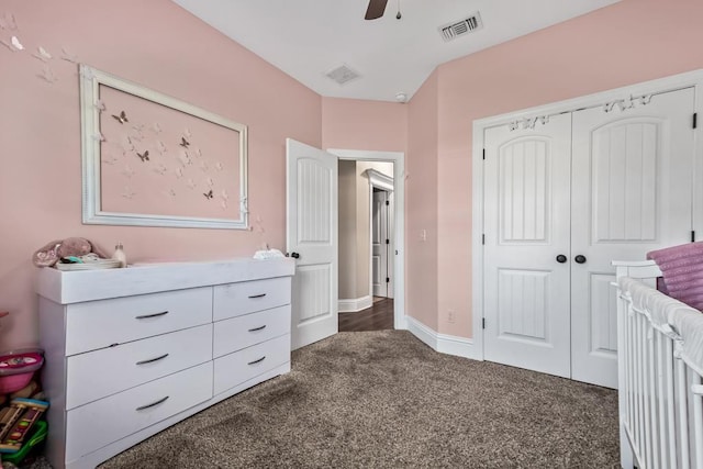 bedroom with a closet, dark colored carpet, and ceiling fan