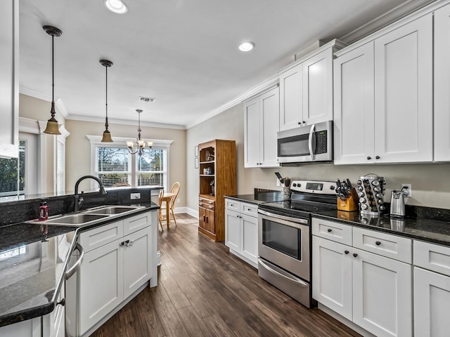 kitchen featuring sink, appliances with stainless steel finishes, white cabinets, and dark stone counters