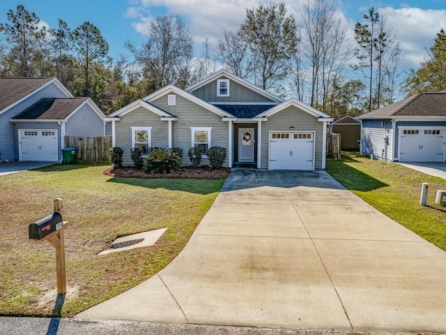 view of front of property with an outbuilding, a front yard, and a garage