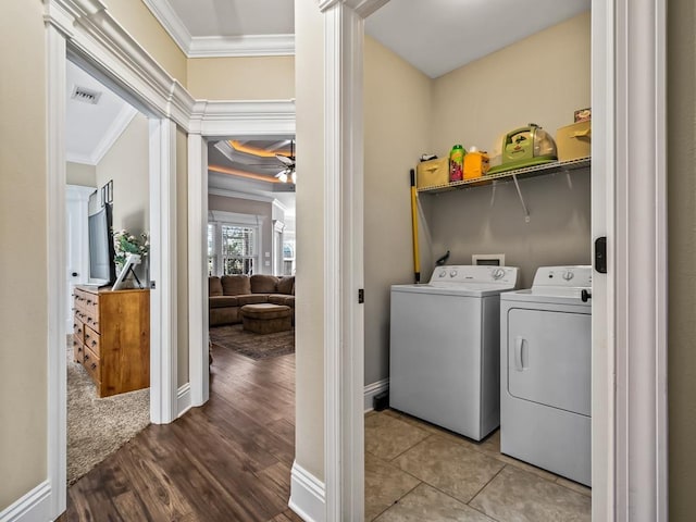 laundry room with washing machine and dryer, crown molding, light wood-type flooring, and ceiling fan