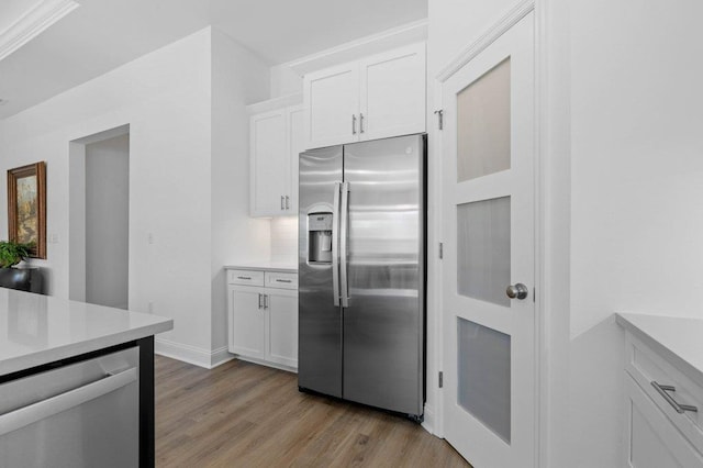 kitchen featuring white cabinetry, appliances with stainless steel finishes, and light hardwood / wood-style flooring