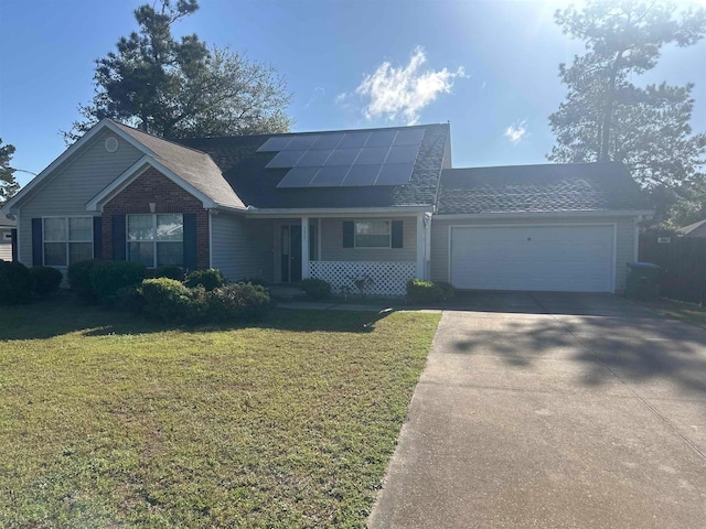 view of front of property featuring driveway, an attached garage, solar panels, and a front lawn