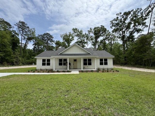 view of front of house with a porch and a front yard