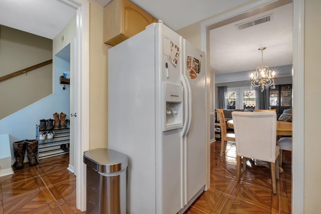 1625 Centerville Rd Unit 20, Tallahassee, FL 32308 - kitchen featuring white fridge with ice dispenser, a chandelier, light brown cabinetry, and pendant lighting