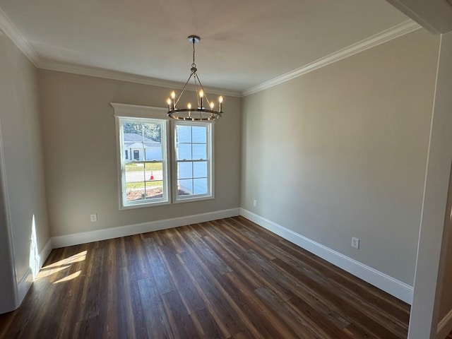 spare room with an inviting chandelier, dark hardwood / wood-style flooring, and ornamental molding