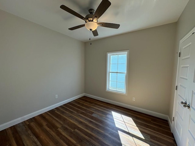 unfurnished room with ceiling fan and dark hardwood / wood-style floors