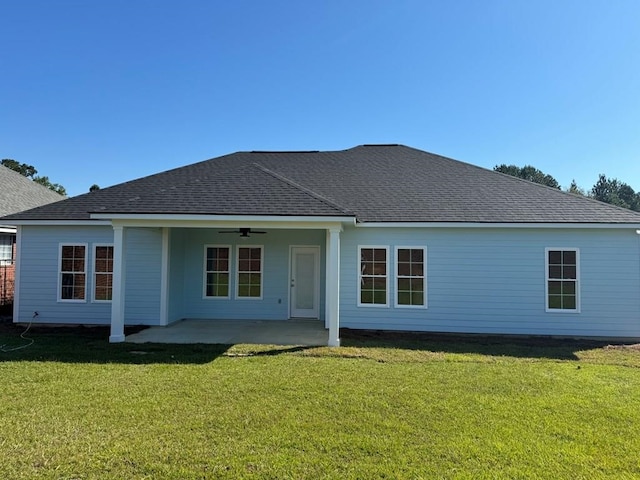 back of house with a patio area, a lawn, and ceiling fan