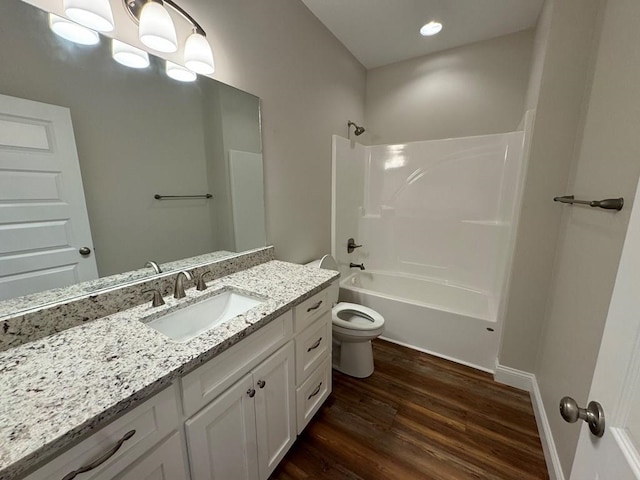 full bathroom featuring toilet, bathing tub / shower combination, vanity, and hardwood / wood-style flooring