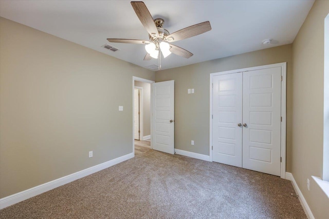 unfurnished bedroom featuring light carpet, a closet, and ceiling fan