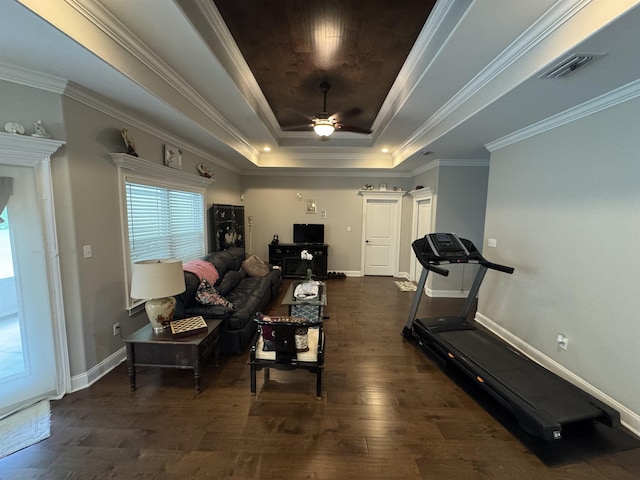 living room with visible vents, wood finished floors, baseboards, ceiling fan, and a raised ceiling
