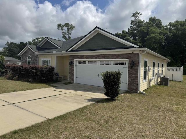 view of front of property featuring a front yard, fence, concrete driveway, an attached garage, and stone siding