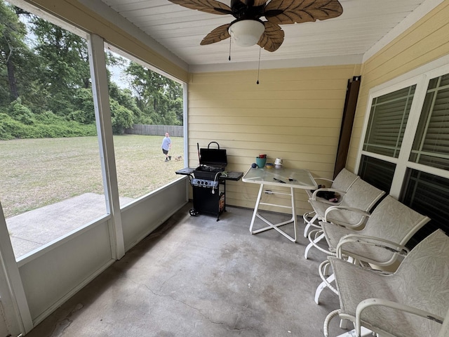 sunroom featuring ceiling fan