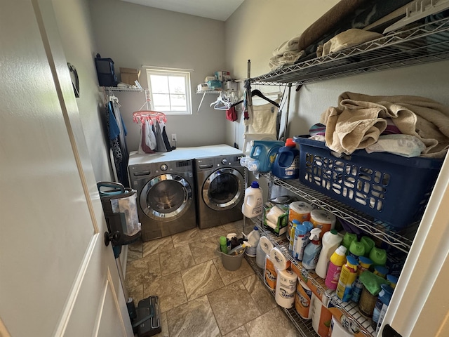 washroom with stone finish floor, laundry area, and washer and dryer
