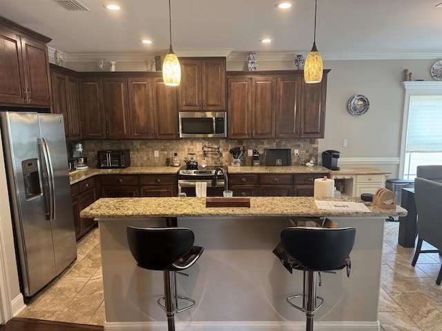 kitchen featuring stainless steel appliances, ornamental molding, a sink, and dark brown cabinets