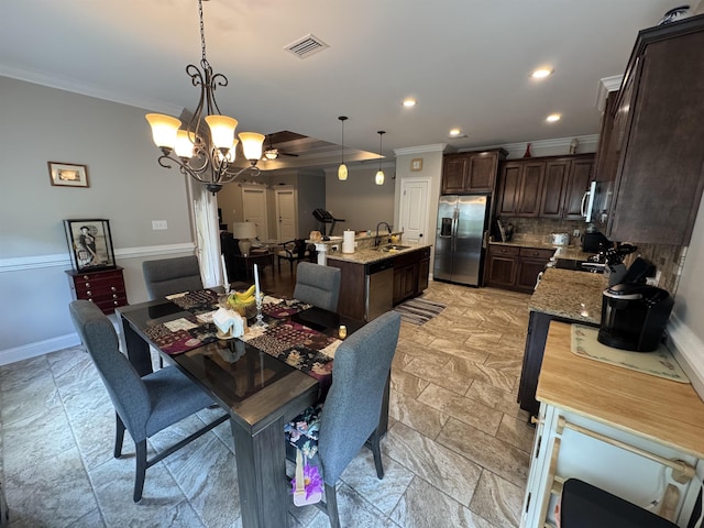 dining room featuring visible vents, an inviting chandelier, ornamental molding, recessed lighting, and stone tile floors