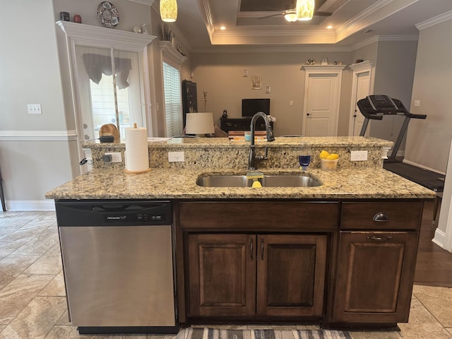 kitchen featuring a sink, baseboards, stainless steel dishwasher, a tray ceiling, and ornamental molding
