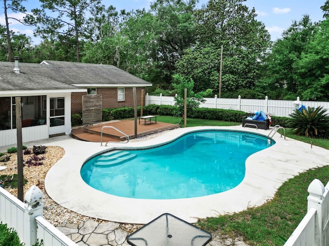 11858 NW State Road 20, Bristol, FL 32321 - view of swimming pool featuring a patio, a fenced backyard, a sunroom, and view of wooded area