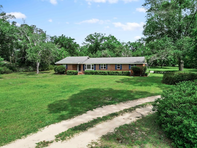 11858 NW State Road 20, Bristol, FL 32321 - ranch-style house featuring brick siding, a front yard, and view of scattered trees