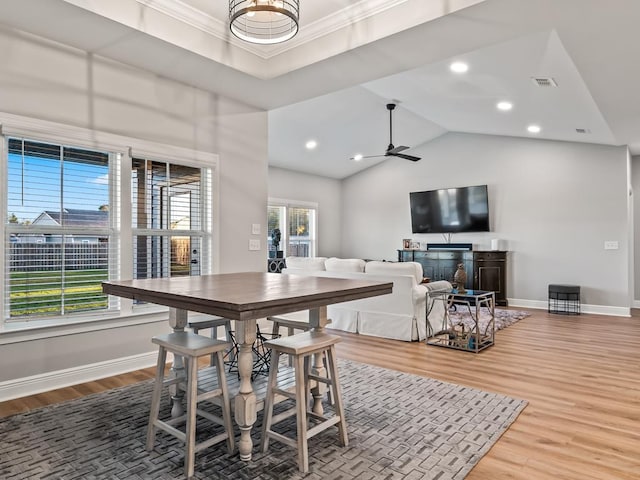 dining space featuring ceiling fan, crown molding, lofted ceiling, and hardwood / wood-style flooring