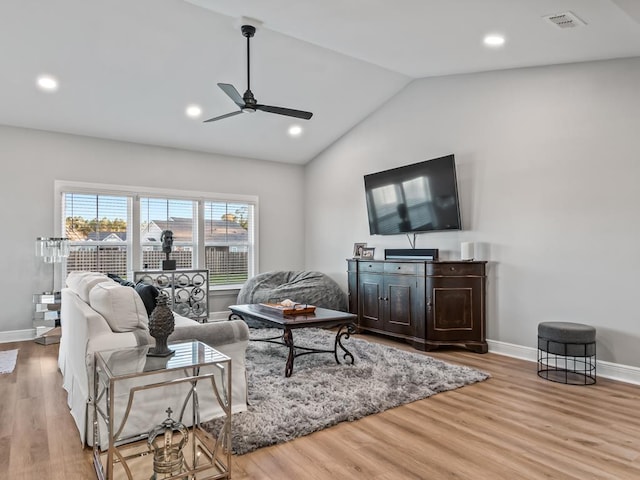 living room featuring light wood-type flooring, vaulted ceiling, and ceiling fan