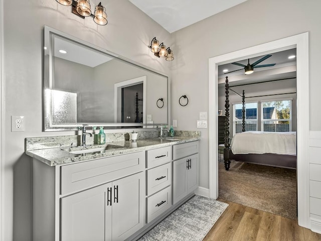 bathroom featuring vanity, hardwood / wood-style flooring, and ceiling fan